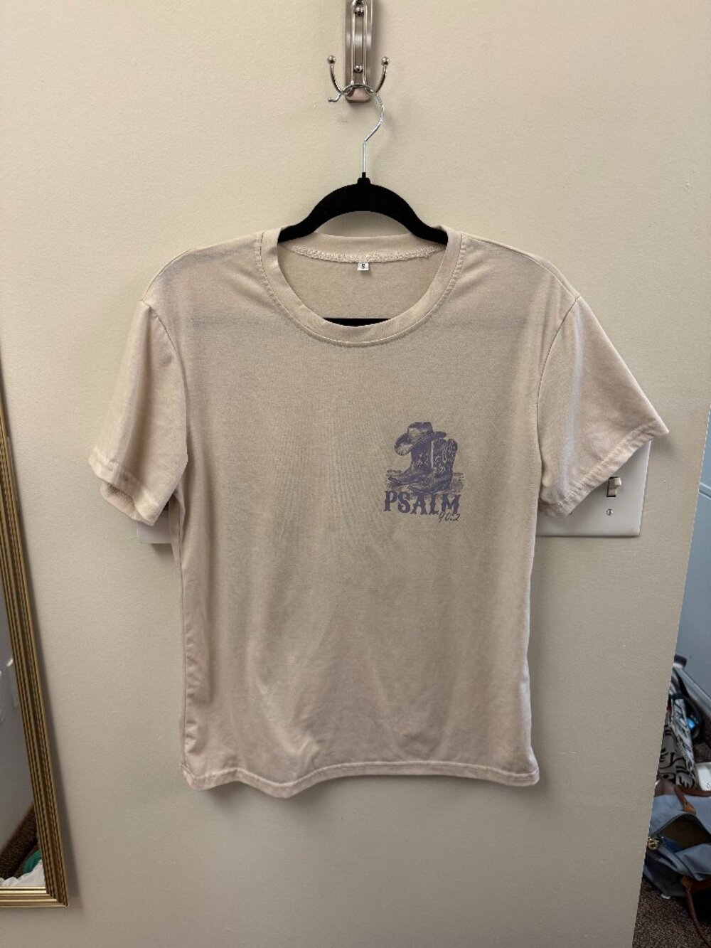 cream t-shirt with purple graphic and letters